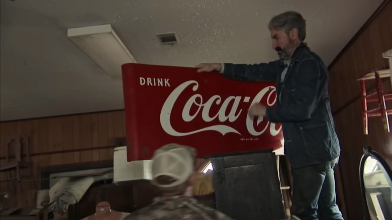 Mike Wolfe with a Coca-Cola sign