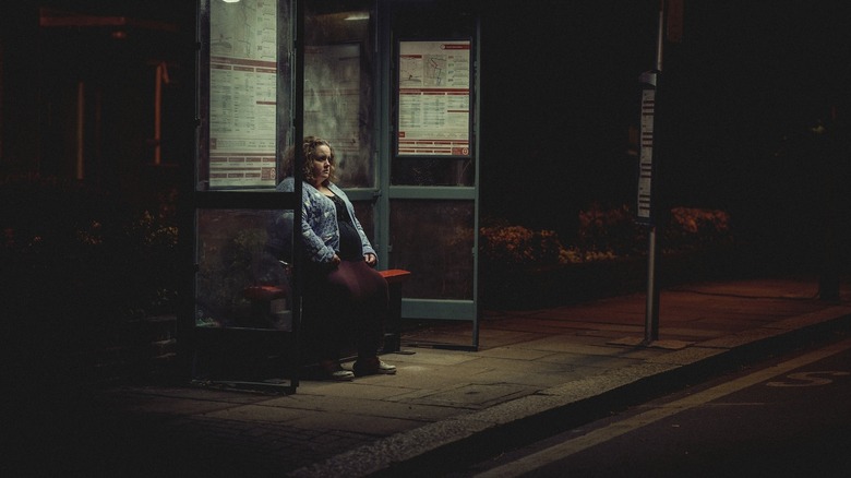 Martha alone at bus stop