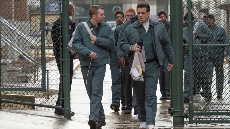 David Sweat (Paul Dano) and Richard walking through a prison gate and having a conversation in "Escape at Dannemora" (2018)