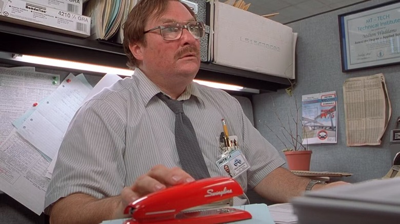 Milton grabbing his red stapler