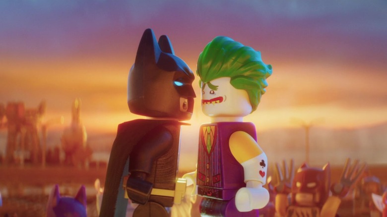 Lego Batman and Lego Joker leaning in close