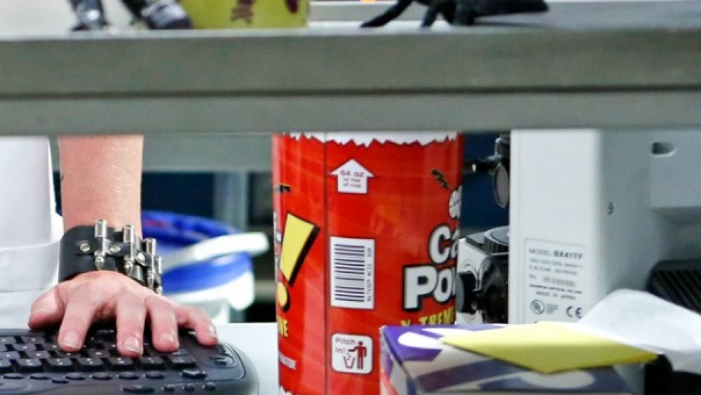 Pauley Perrette's hand as Abby Sciuto next to a cup of Caf-Pow in her lab in NCIS