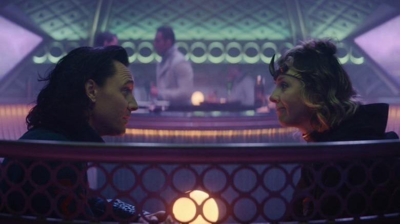 Loki and Lady Loki sitting at a table