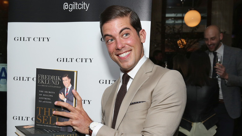 Luis D. Ortiz holding a book