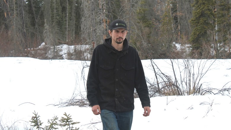 Parker Schnabel looking ahead while walking in a snowy field during Gold Rush Season 14