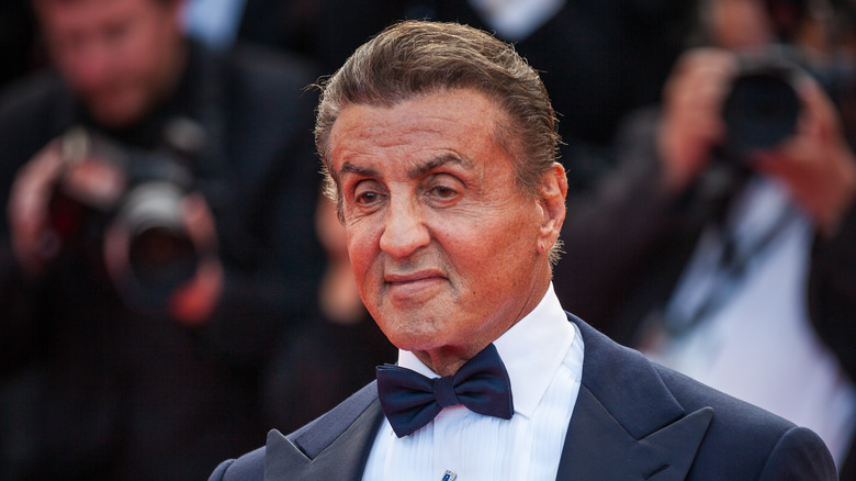 Sylvester Stallone sneering in tuxedo