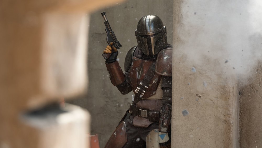 The Mandalorian with his trusty sidearm blaster