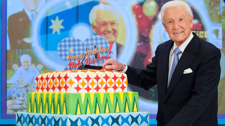 Bob Barker smiles with a birthday cake