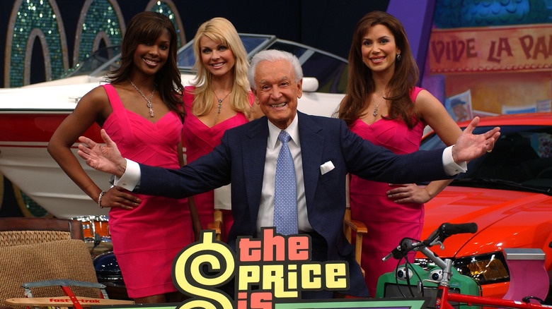 Bob Barker smiling with three models