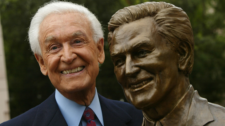 Bob Barker smiles with a statue of himself