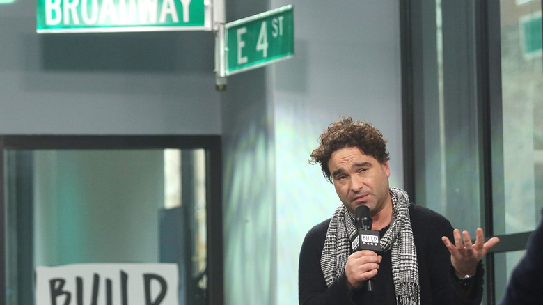 Johnny Galecki in front of street signs