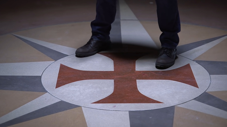 Feet on templar cross design