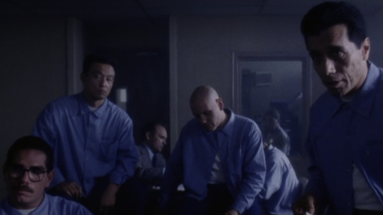 Men in prison sitting