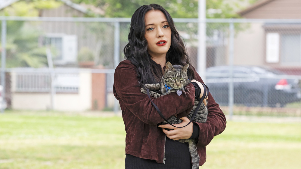 Kat Dennings as Jules Wiley holding a cat in Dollface