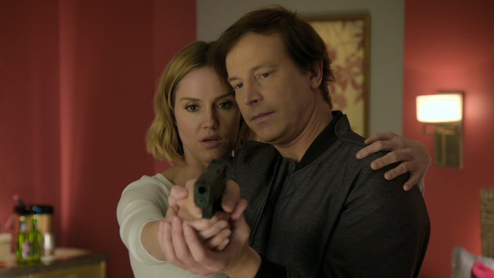 Erinn Hayes and Rob Huebel pointing a gun