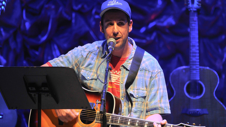 Adam Sandler playing guitar