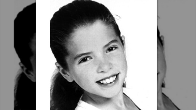 Young Anna Kendrick smiles