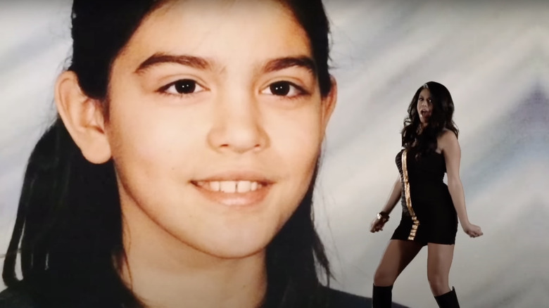 Cecily Strong dancing in front of her high school photo