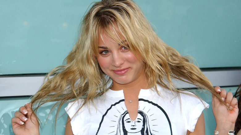 Kaley Cuoco holds her hair