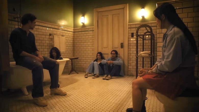 Friends sitting around a bathroom in Until Dawn trailer