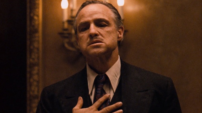 Vito Corleone with hand on heart