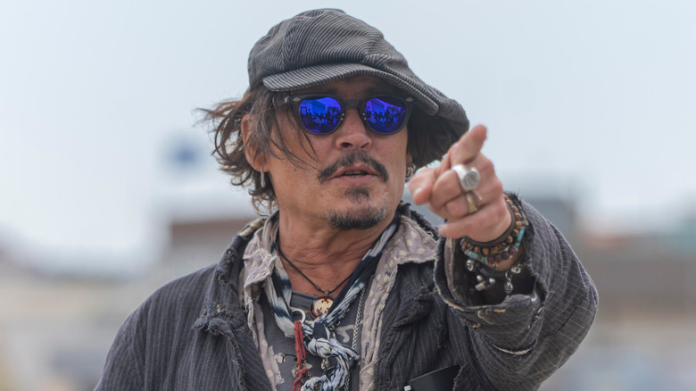 Depp standing and pointing