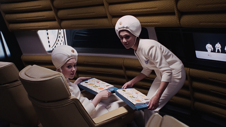 Futuristic flight attendants serve guests