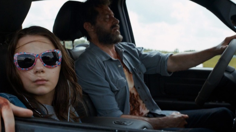 Laura wearing glasses while Logan drives