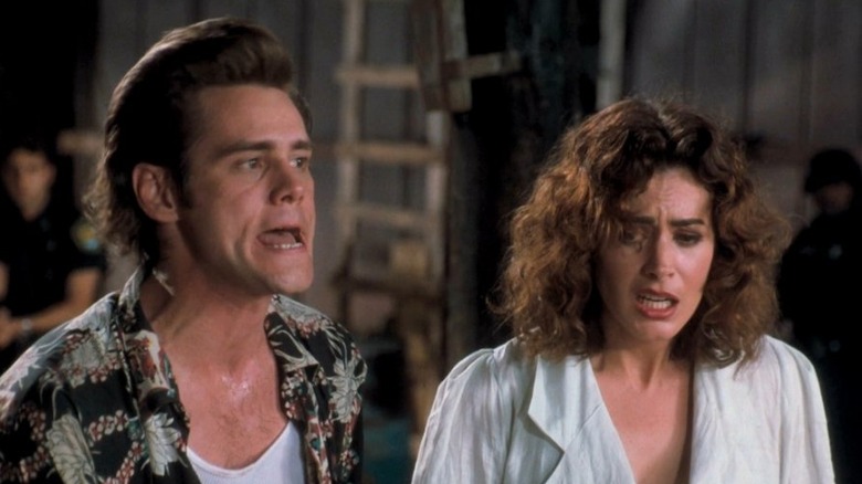 Jim Carrey and Sean Young grimacing 