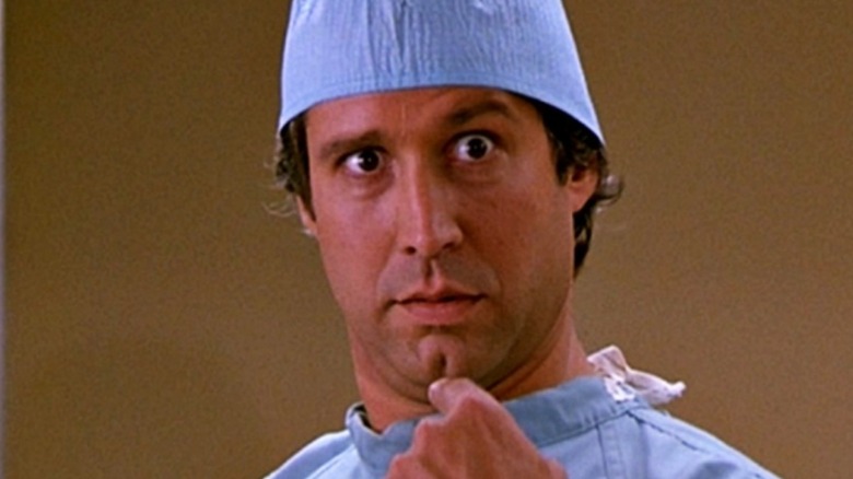 Chevy Chase as Fletch points at himself