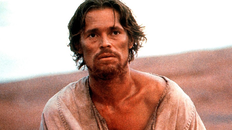 Willem Dafoe as Jesus stands in the desert