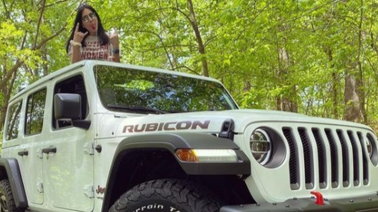 Alaqua Cox posing next to her new jeep