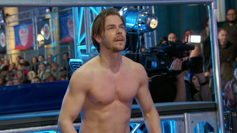 Derek Hough shirtless looking up on course