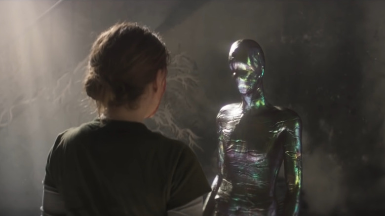 Metallic alien facing Lena 