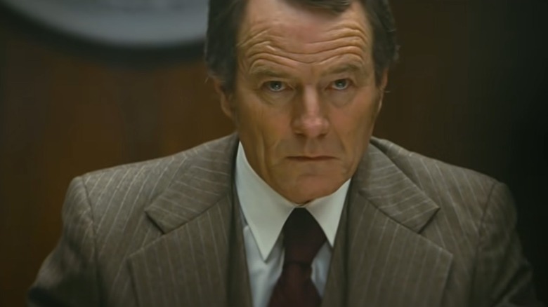 Bryan Cranston looks up sternly