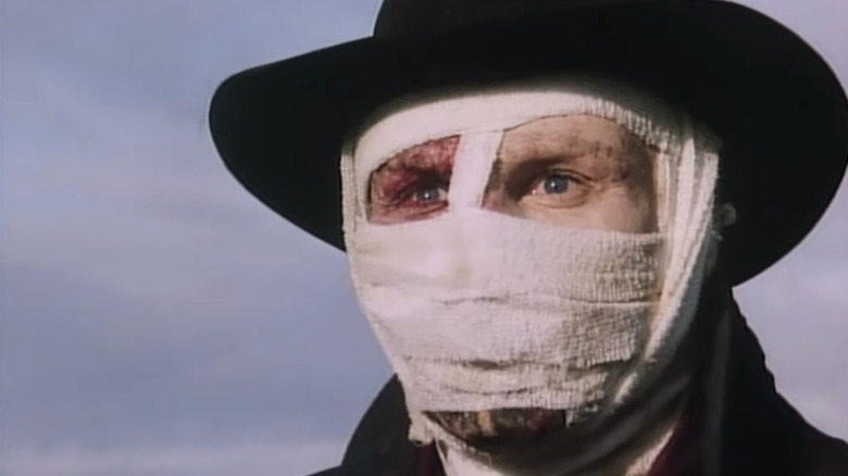 Darkman in bandages with a black hat