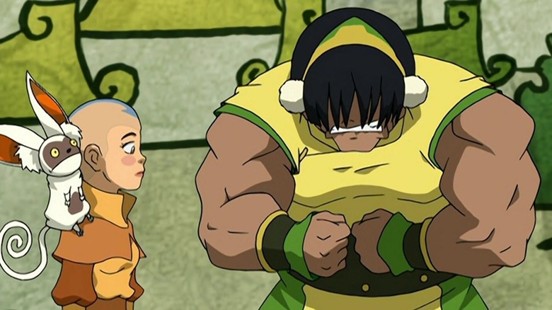 Toph actor flexing muscles