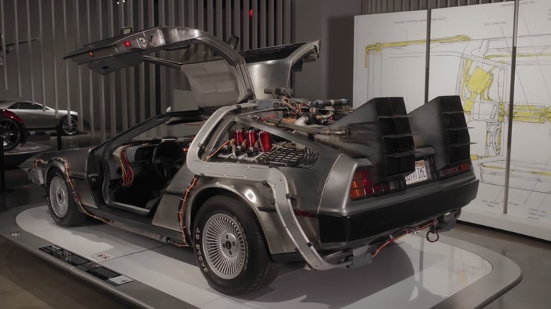 The DeLorean sitting with the gull-wing doors open