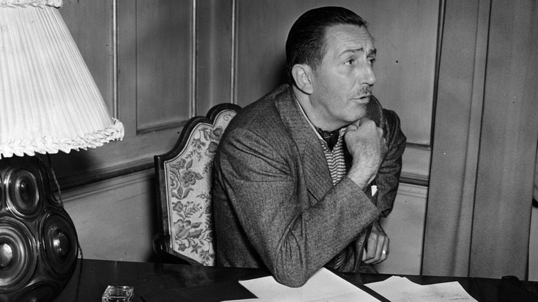 Walt Disney sitting at desk