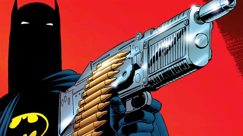 Batman holds a gun