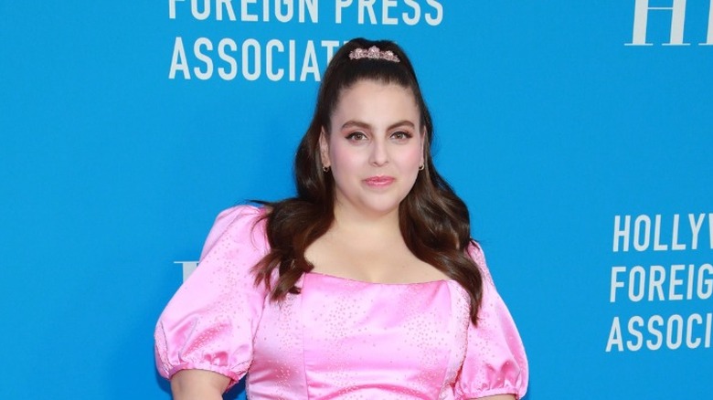 Beanie Feldstein smiling on red carpet