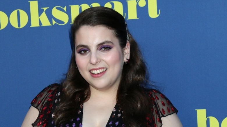 Beanie Feldstein smiling on red carpet