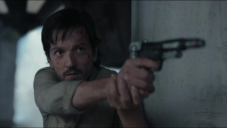 Cassian aims his blaster