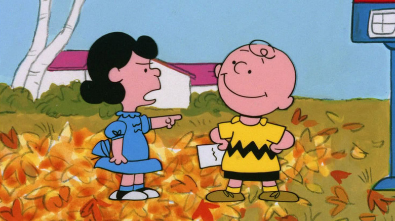 Lucy points at Charlie Brown