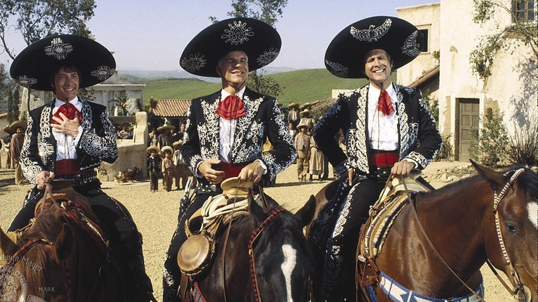 Three Amigos sit on horses