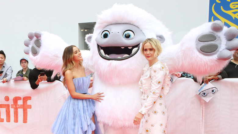 Chloe Bennet posing with an abominable snowman