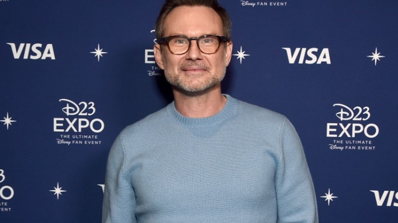 Christian Slater wearing blue sweater