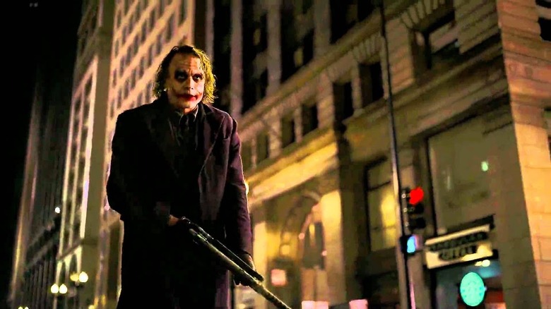 Joker holds a gun in the street