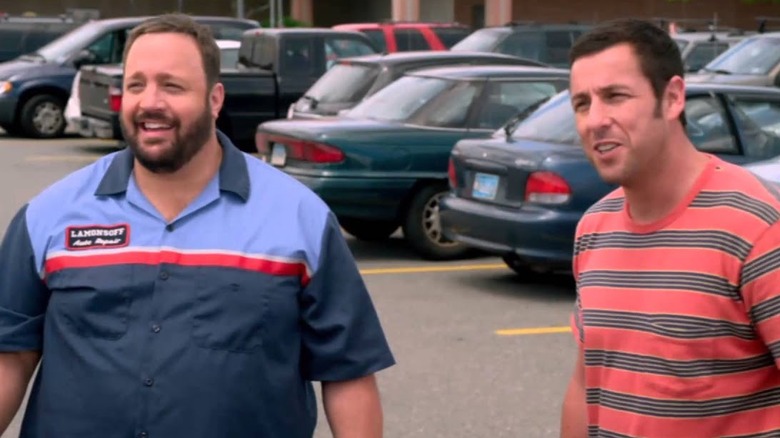 Eric and Lenny stand next to each other in a parking lot