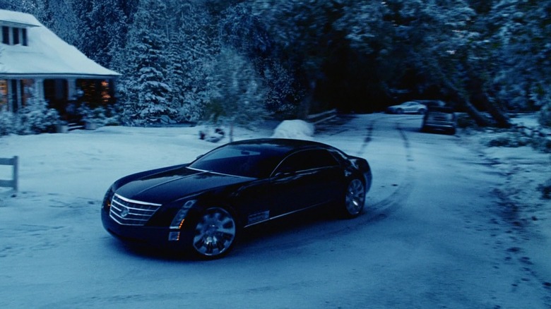 A Cadillac car pulls up to a snowy driveway